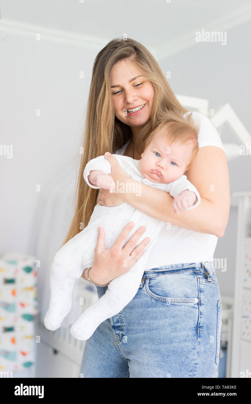 Mom and newborn baby in her arms. The concept of new life, love and helplessness Stock Photo