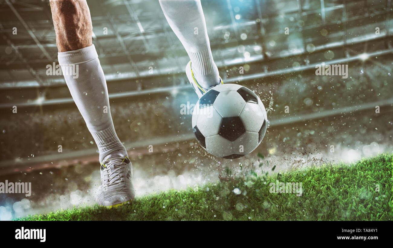 Football scene at night match with player ready to shoot the ball Stock Photo