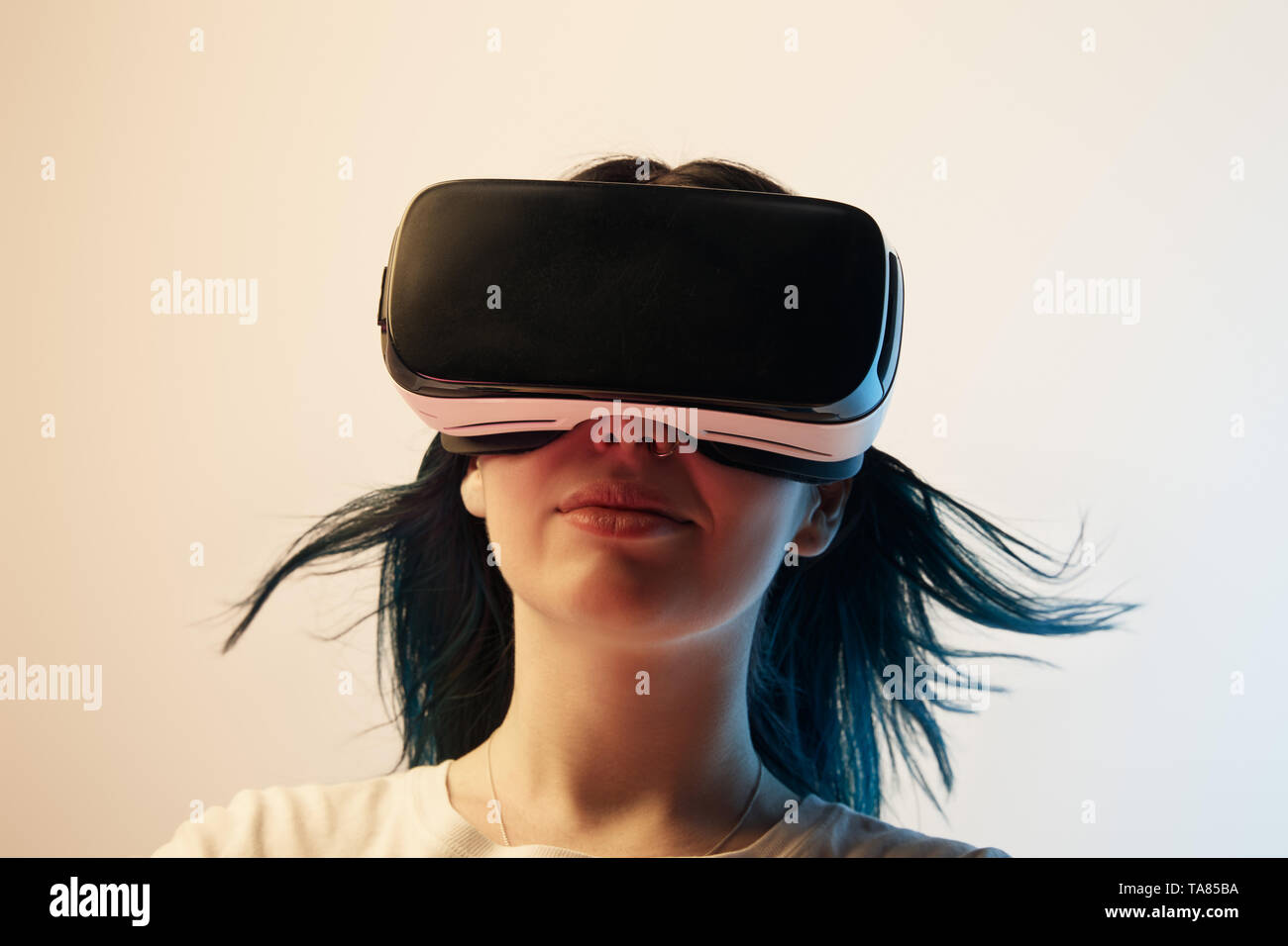 brunette girl wearing virtual reality headset on beige Stock Photo - Alamy
