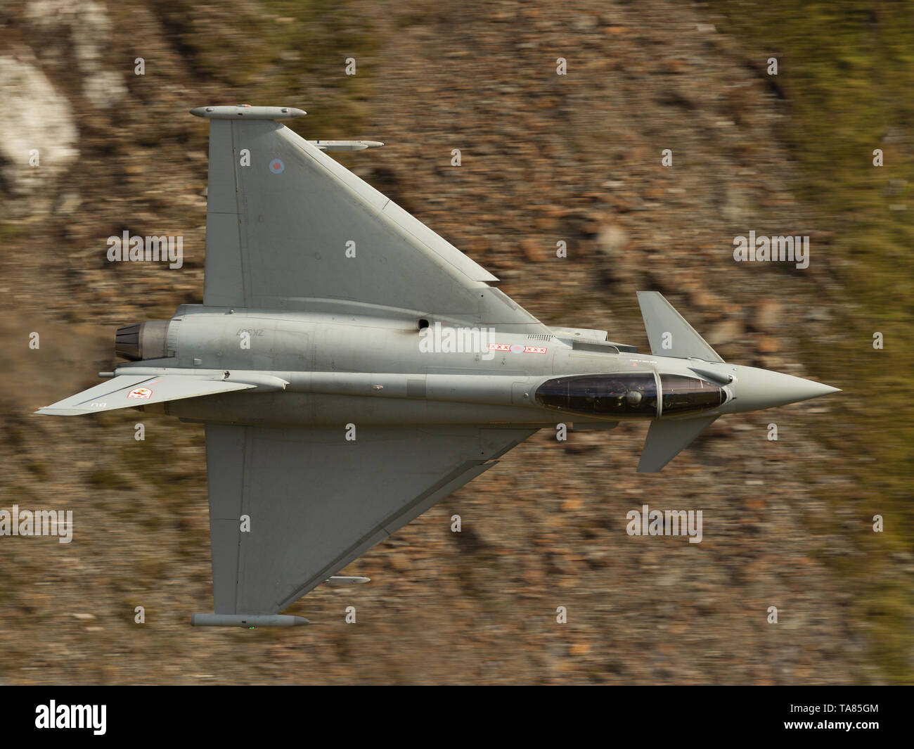 RAF Eurofighter Typhoon flying low level through the Mach Loop In Wales, UK Stock Photo