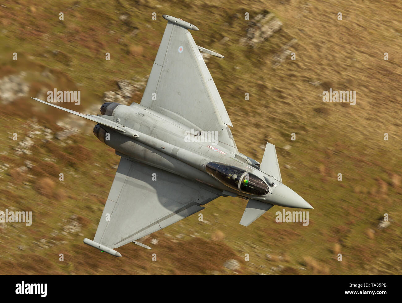 RAF Eurofighter Typhoon flying low level through the Mach Loop In Wales, UK Stock Photo
