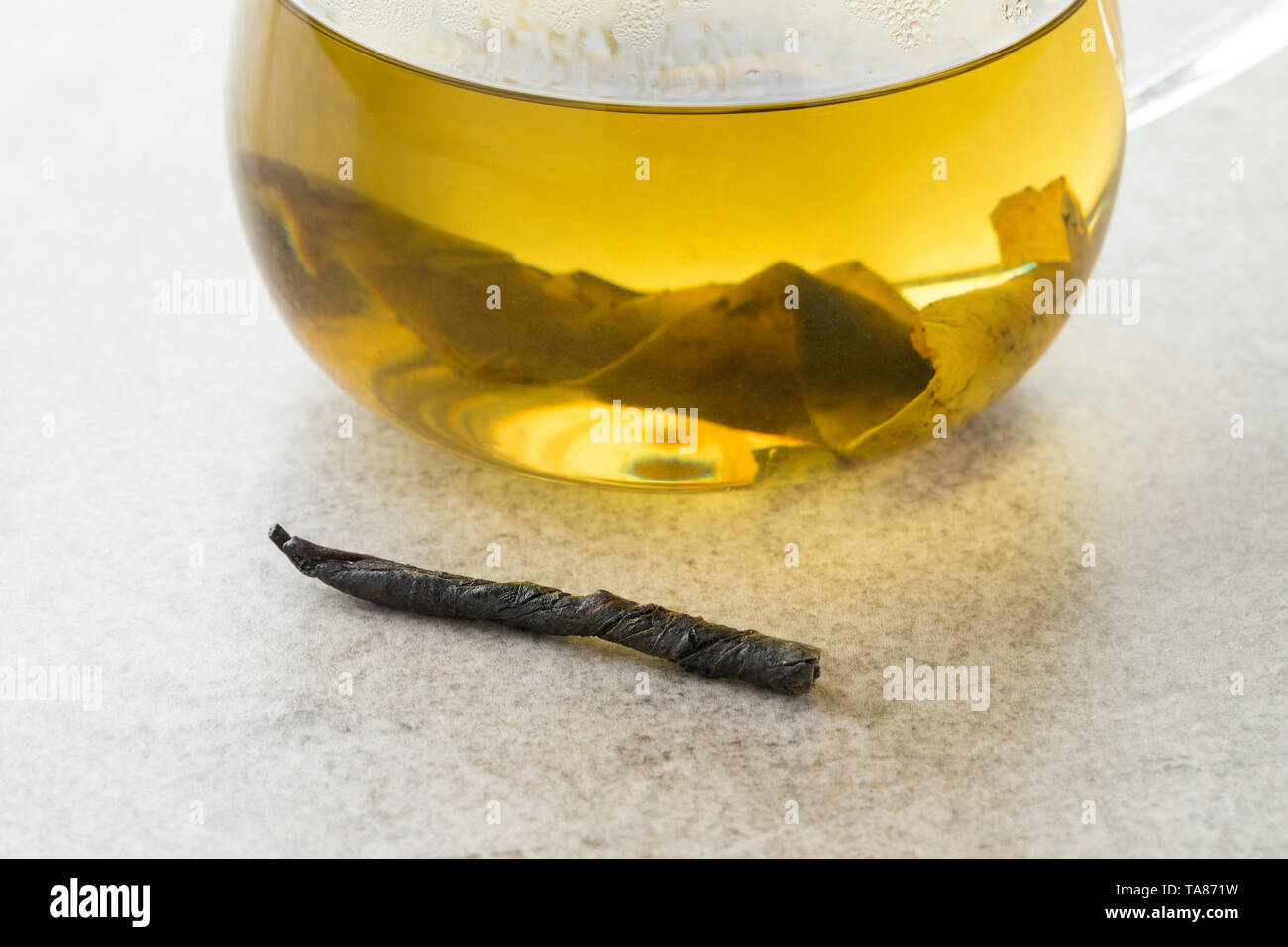 Glass cup of natural Chinese Kuding needle tea close up Stock Photo