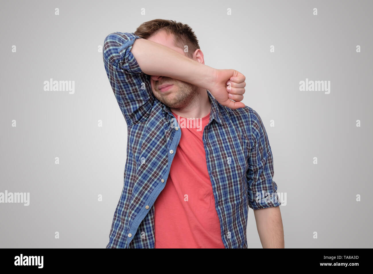 Feeling depressed. Man covering face with hand Stock Photo