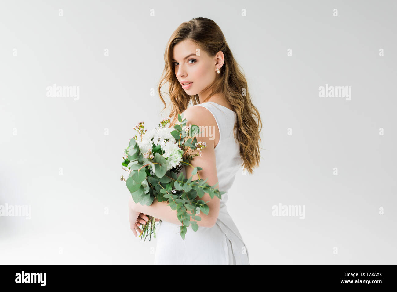 Girl in white holding flowers hi-res stock photography and images - Alamy