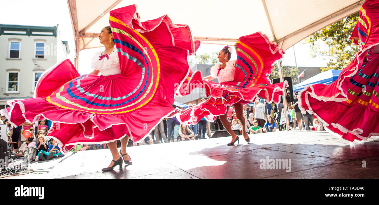 Group of Female Mexican Dancers with Flowing Pink Skirts Performing on Stage at Folk Festival, 'One River, Many Streams' Folk Festival, Part of Spirit of Beacon Festival, Beacon, New York, USA Stock Photo