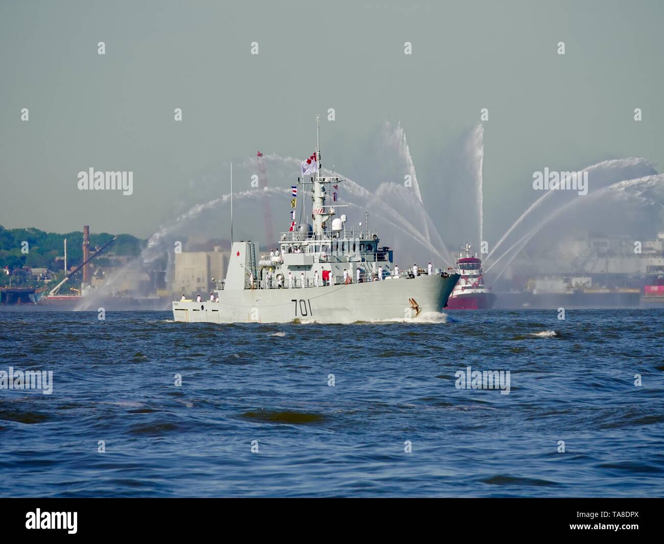 HMCS Glace Bay, Royal Canadian Navy Maritime Coastal Defence Vessel, sailing in front of a fire boat streaming water, Fleet Week, New York, NY, USA Stock Photo