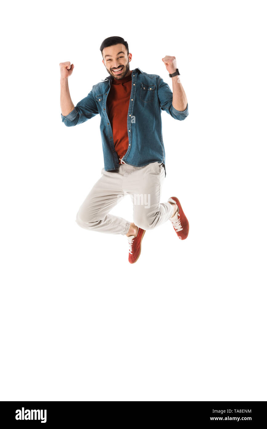 happy man jumping and showing winner gesture isolated on white Stock Photo