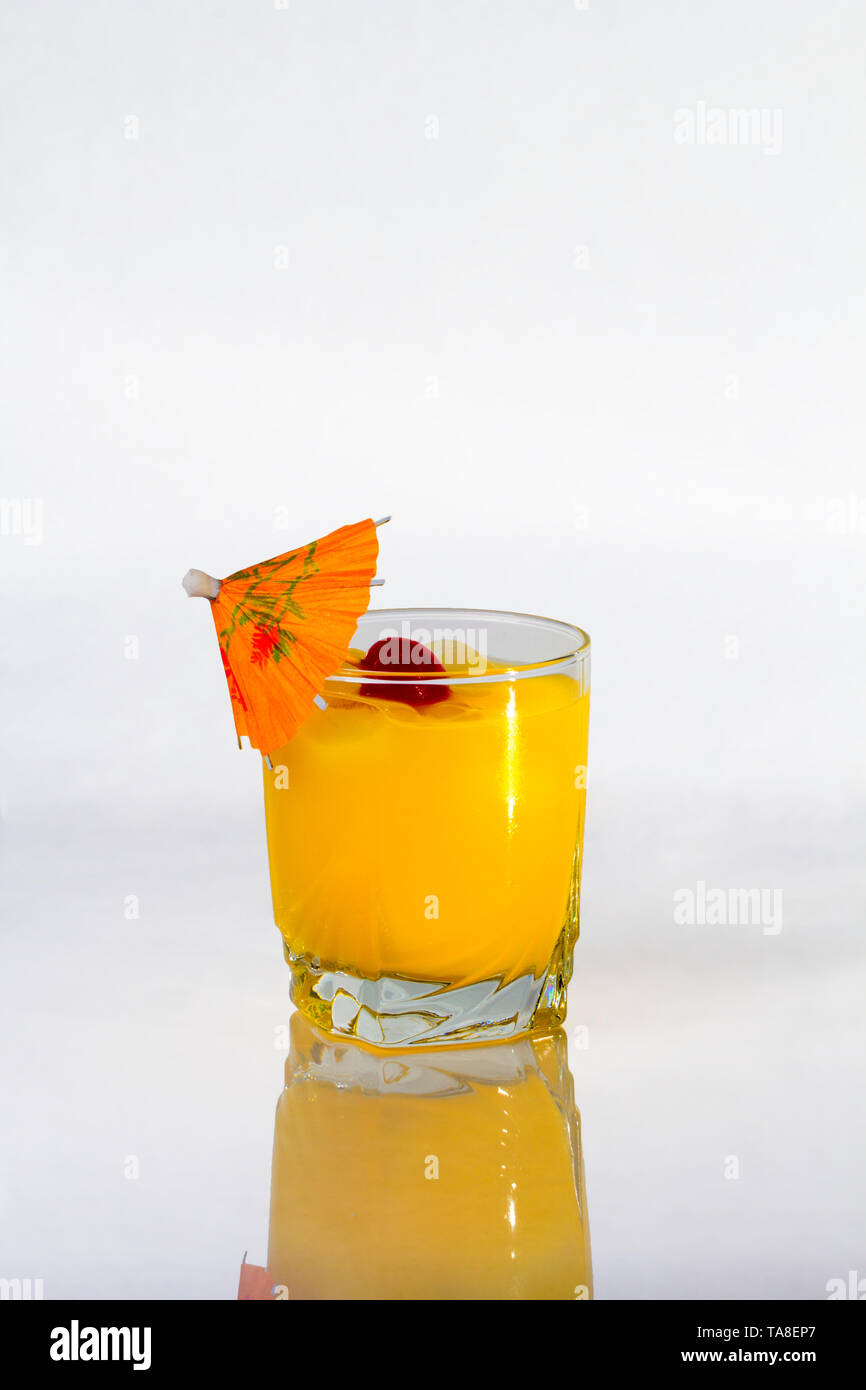 Vodka and Orange juice mixed drink with a cocktail umbrella. Stock Photo