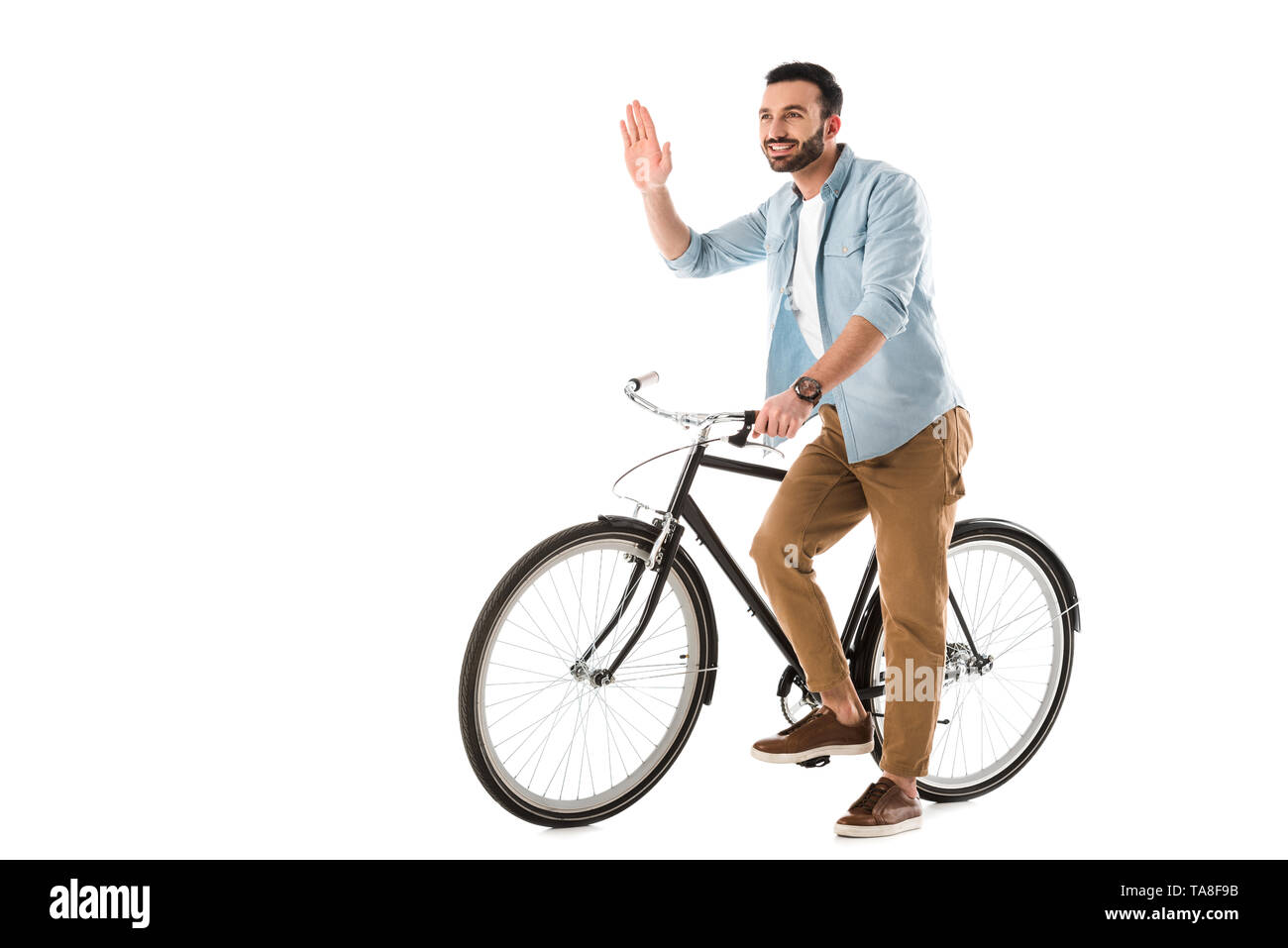 cheerful man with bicycle showing hello gesture and looking away isolated on white Stock Photo