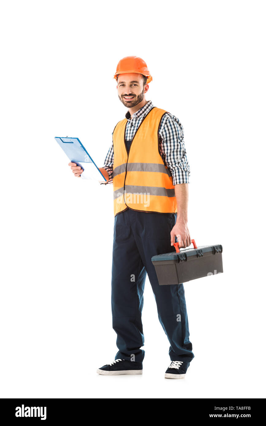 cheerful construction worker holding toolbox and clipboard isolated on white Stock Photo