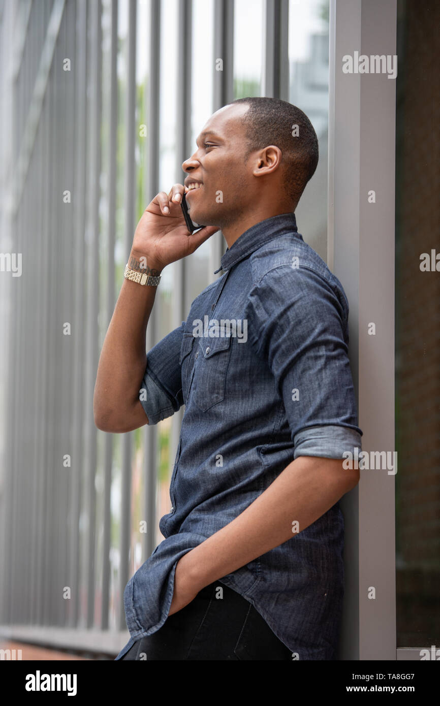 African american man standing phone hi-res stock photography and images ...