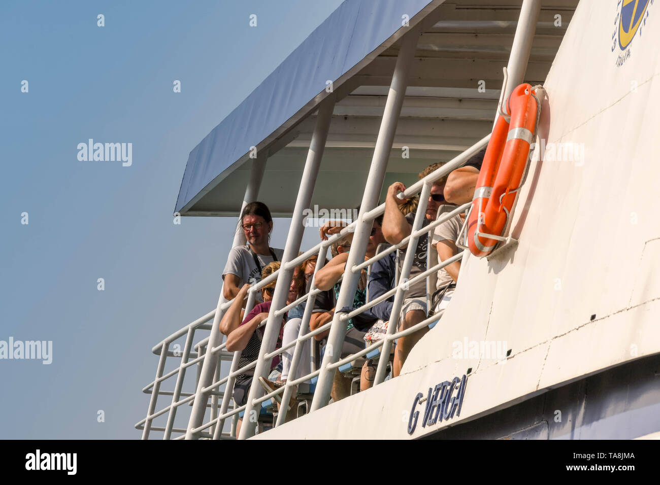 GARDA, LAKE GARDA, ITALY - SEPTEMBER 2018: People on the top deck of a passenger ferry at the town of Garda on Lake Garda. Stock Photo