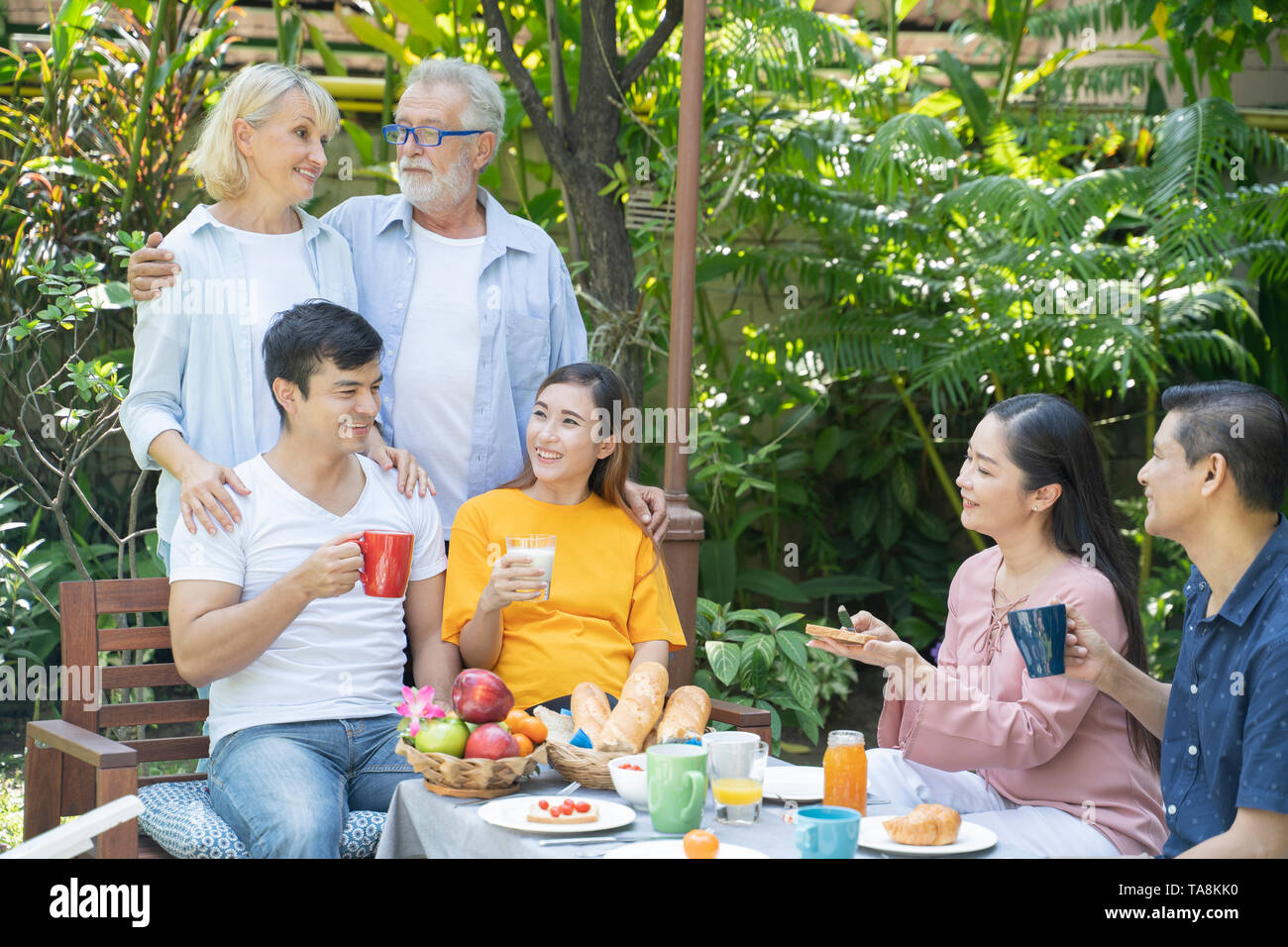 The happiness of two ethnic families - Image Stock Photo