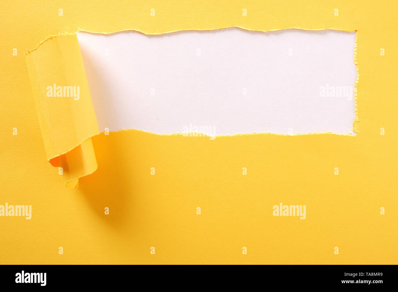 Torn yellow paper strip white background ripped Stock Photo