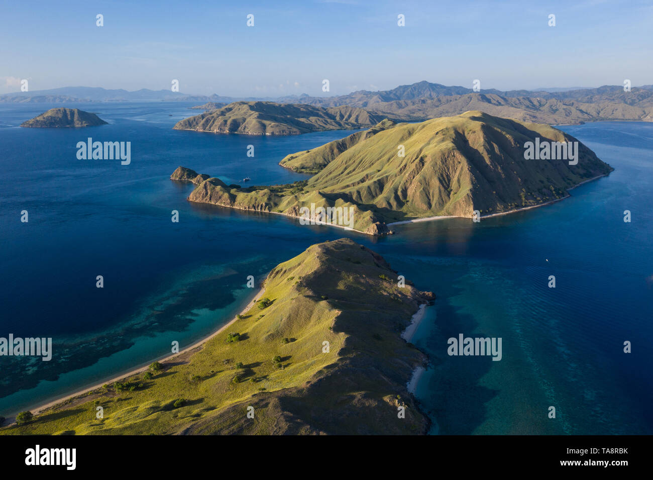 Seen from an aerial view, afternoon light shines on rugged islands in Komodo National Park 
