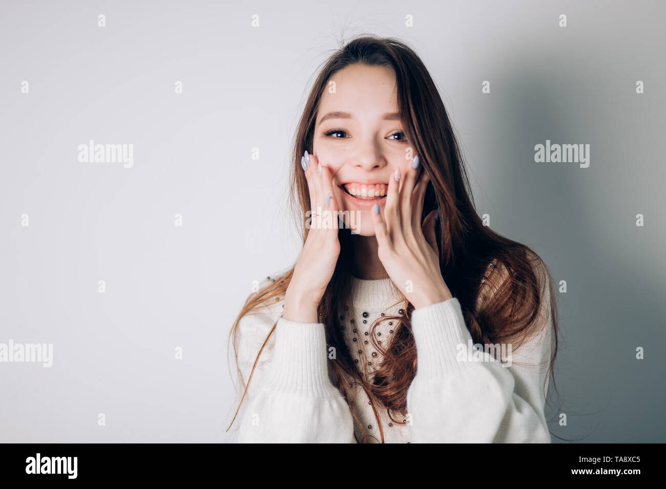 Surprised happy beautiful woman on white background Stock Photo - Alamy