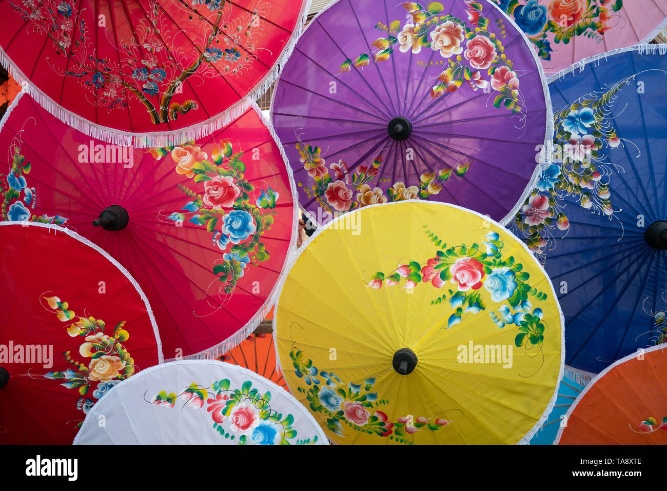 colorful handmade paper umbrella with flower painting. popular and famous Thai handicraft and souvenir. Stock Photo