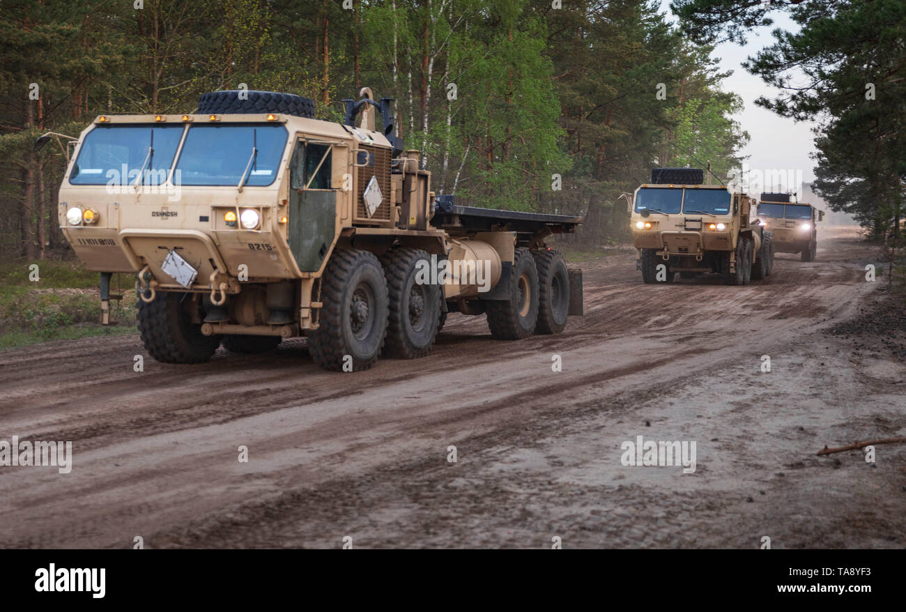 Trucks from 1st Squadron, 4th Cavalry Regiment, 1st Armored Brigade Combat Team, 1st Infantry Division roll out, during an Initial Ready Task Force (IRTF) exercise, at Johanna Range, Poland, May 20, 2019. An IRTF is similar to an Emergency Deployment Readiness Exercise (EDRE) but on a smaller scale. An IRTF is a no-notice, rapid-deployment exercise designed to test a unit's ability to alert, marshal, and deploy forces and equipment for contingency operations or an emergency disaster.  (U.S. Army photo by Sgt. Thomas Mort) Stock Photo