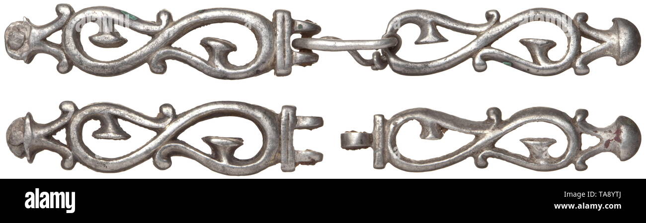 A pair of silver Roman strap ends, late 2nd - mid 3rd century A pair of two-piece strap ends from a military belt with a pierced pattern of S-shaped scrolls, forked at top as strap holder with rivet for leather mounting. In the centre a hinge with iron pin. At bottom movable pendant. One strap with ancient repair of silver wire and soldering of a crack to reconnect both parts after one piece of the hinge was broken off. Provenance: Rhenish art dealer. historic, historical, Roman Empire, ancient world, ancient times, ancient world, Additional-Rights-Clearance-Info-Not-Available Stock Photo