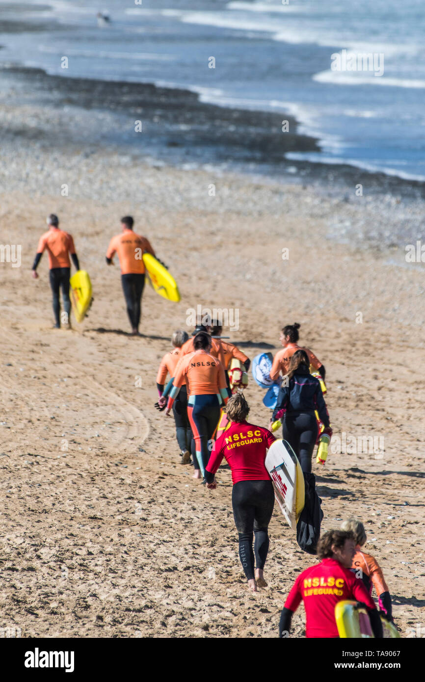 NSLSC members of a Surf Rescue training session with their instructors on Fistral Beach in Newquay in Cornwall. Stock Photo