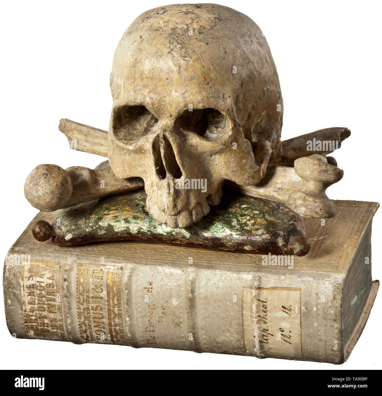 A German memento mori - book and skull, mid-18th century Fully sculpted, carved wooden skull, resting on crossbones and a carved cushion. Old colouring. Also, a book with the original embossed leather binding. 'Theologica Universa', Augsburg 1760, 424 pages, the title page with copper etching. Decorative set. Height of the skull 12 cm, with book 17 cm. historic, historical, 18th century, Additional-Rights-Clearance-Info-Not-Available Stock Photo