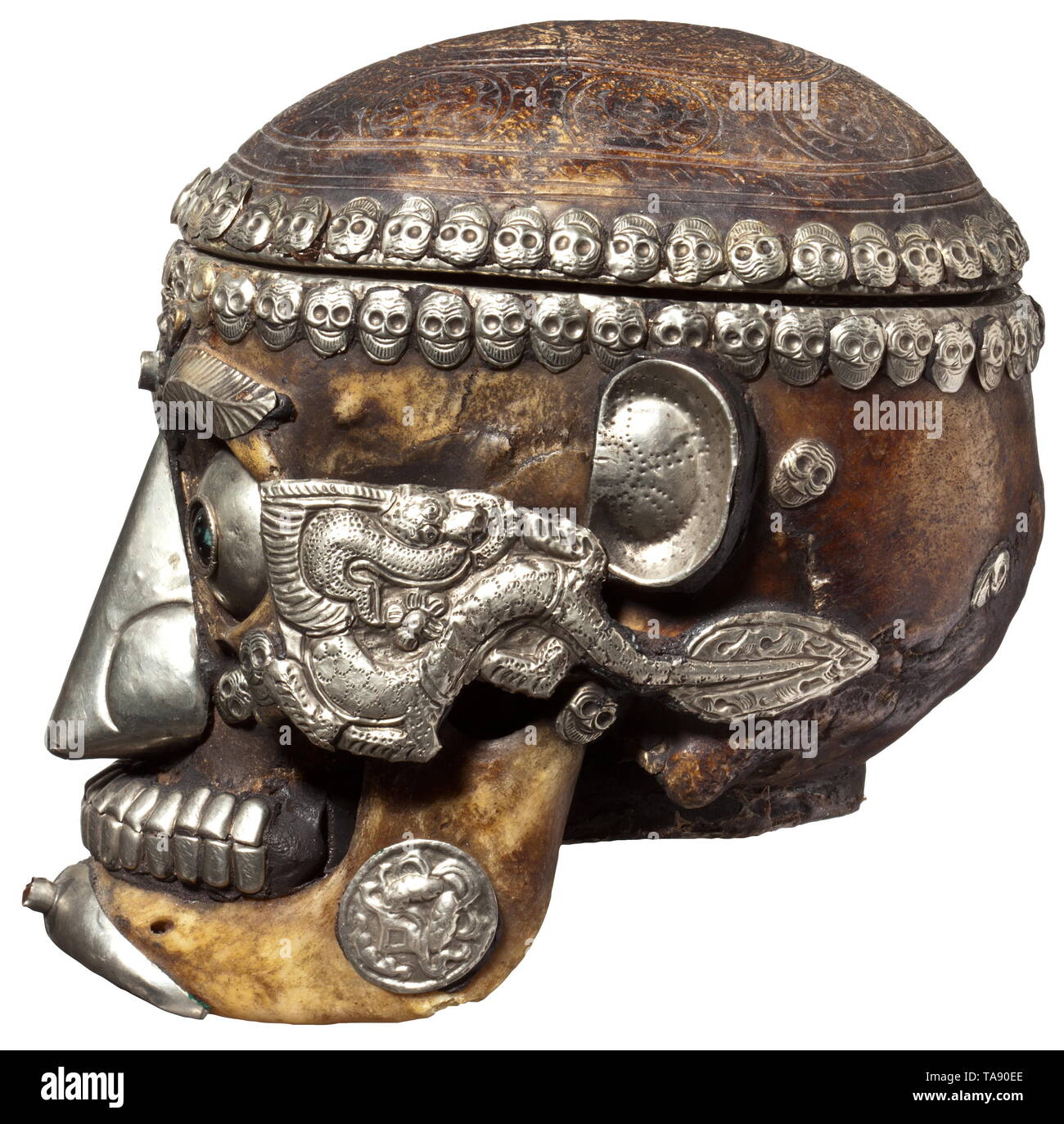 A Tibetan ritual skull Human skull with ornamental engravings, the skullcap opening on a hinge, the interior lined with sheet silver. The eyes, eyebrows, nose, ears, teeth and chin all replaced with silver replicas. The cheekbones and lower jaw decorated with delicately punched silver overlays. Height 19 cm. historic, historical, Asia, Asian, Far East, Tibetan, Nepalese, Nepali, object, objects, stills, clipping, clippings, cut out, cut-out, cut-outs, Additional-Rights-Clearance-Info-Not-Available Stock Photo