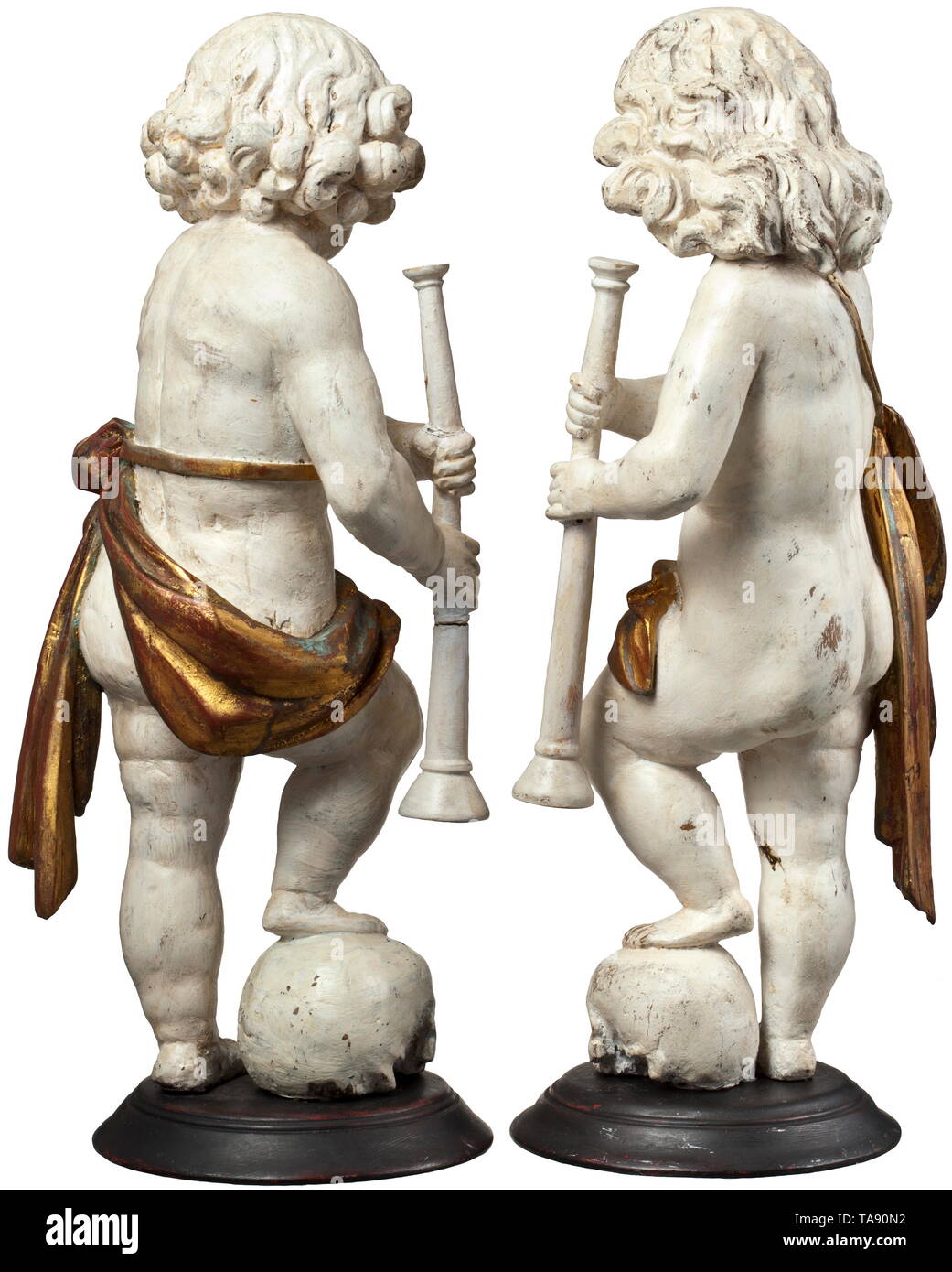 A pair of German or Flemish cherubs, circa 1700 Three-dimensional carved figures of lime wood with old paint in white and gold. Depiction of boys in loincloths, each holding a flute and with a foot resting on a skull. On a round plinth (supplemented?). Height of each 50 cm. historic, historical, fine arts, art, 18th century, Additional-Rights-Clearance-Info-Not-Available Stock Photo