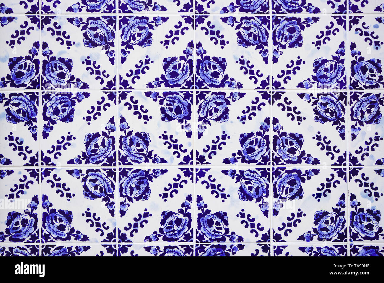 Gorgeous traditional Portuguese ceramic blue tiles with floral pattern. Vintage glazed tiles texture and background. Stock Photo