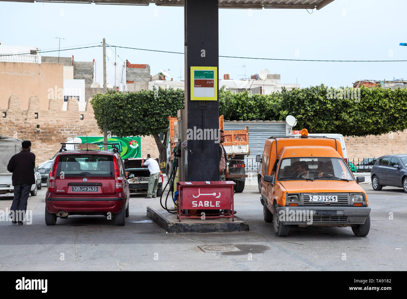 TUNISIA, AFRICA-CIRCA MAY, 2012: Drivers refuel cars on petrol station of Total company with gasoline. Total is a French multinational integrated oil  Stock Photo