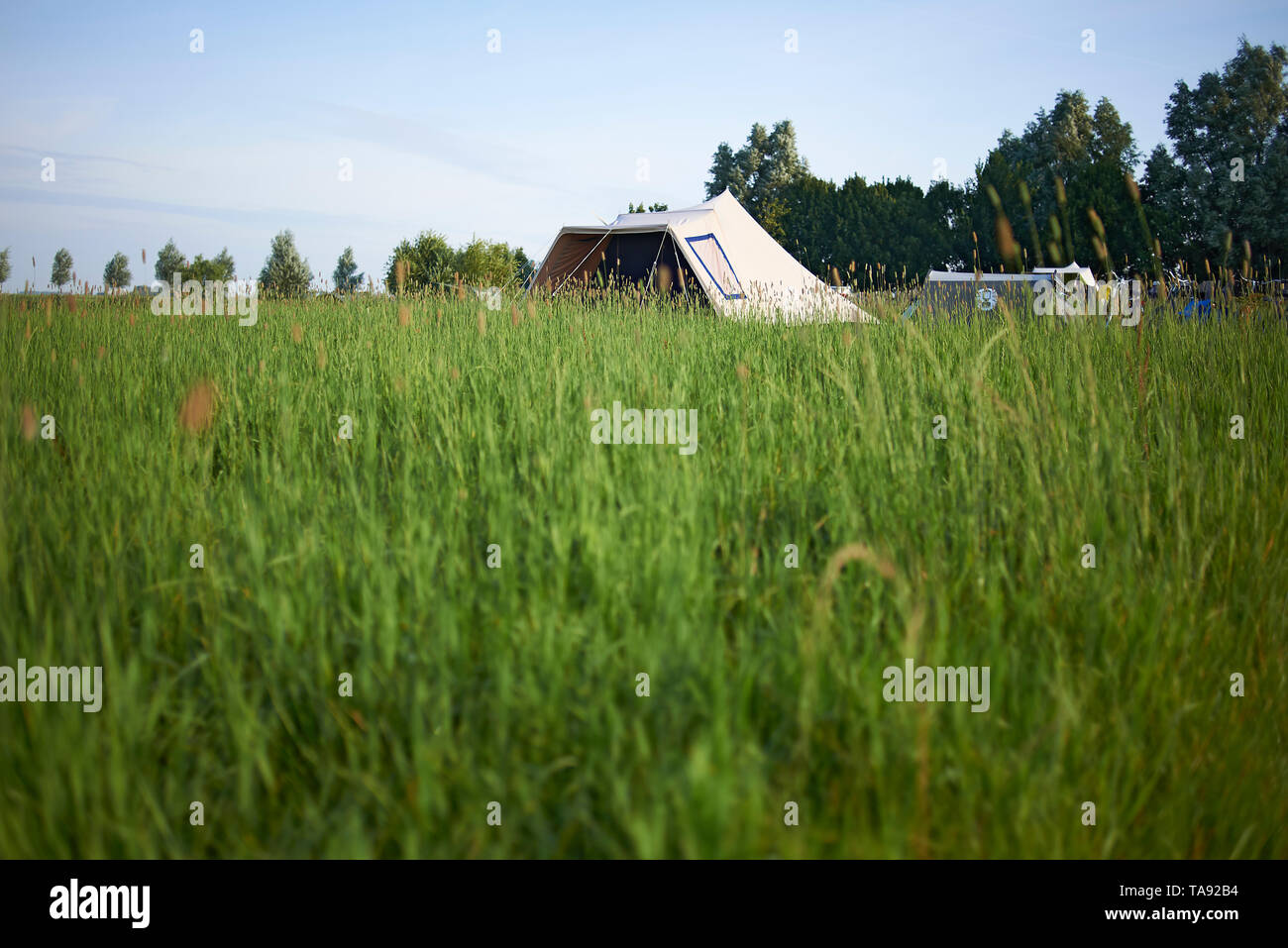 Beautiful landscape in summer sunshine with a tent set up in the middle ...