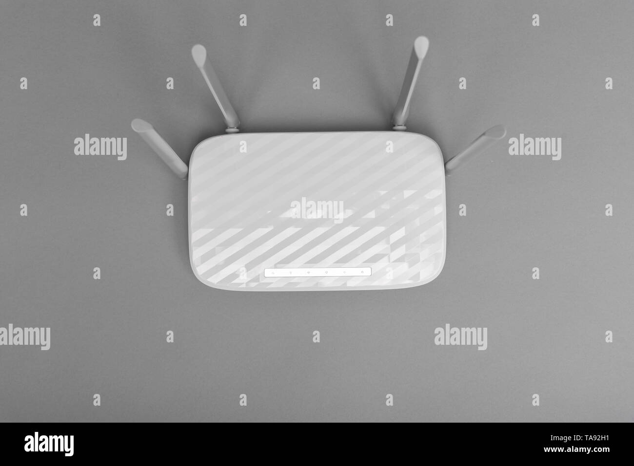 White modern Wi-Fi router with four antennas on gray background Stock ...