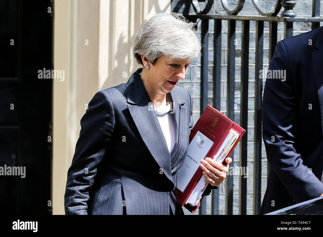British Prime Minister Theresa May is seen departing from Number 10 Downing Street to attend Prime Minister's Questions (PMQs) in the House of Commons on the eve of European Parliament elections. Stock Photo