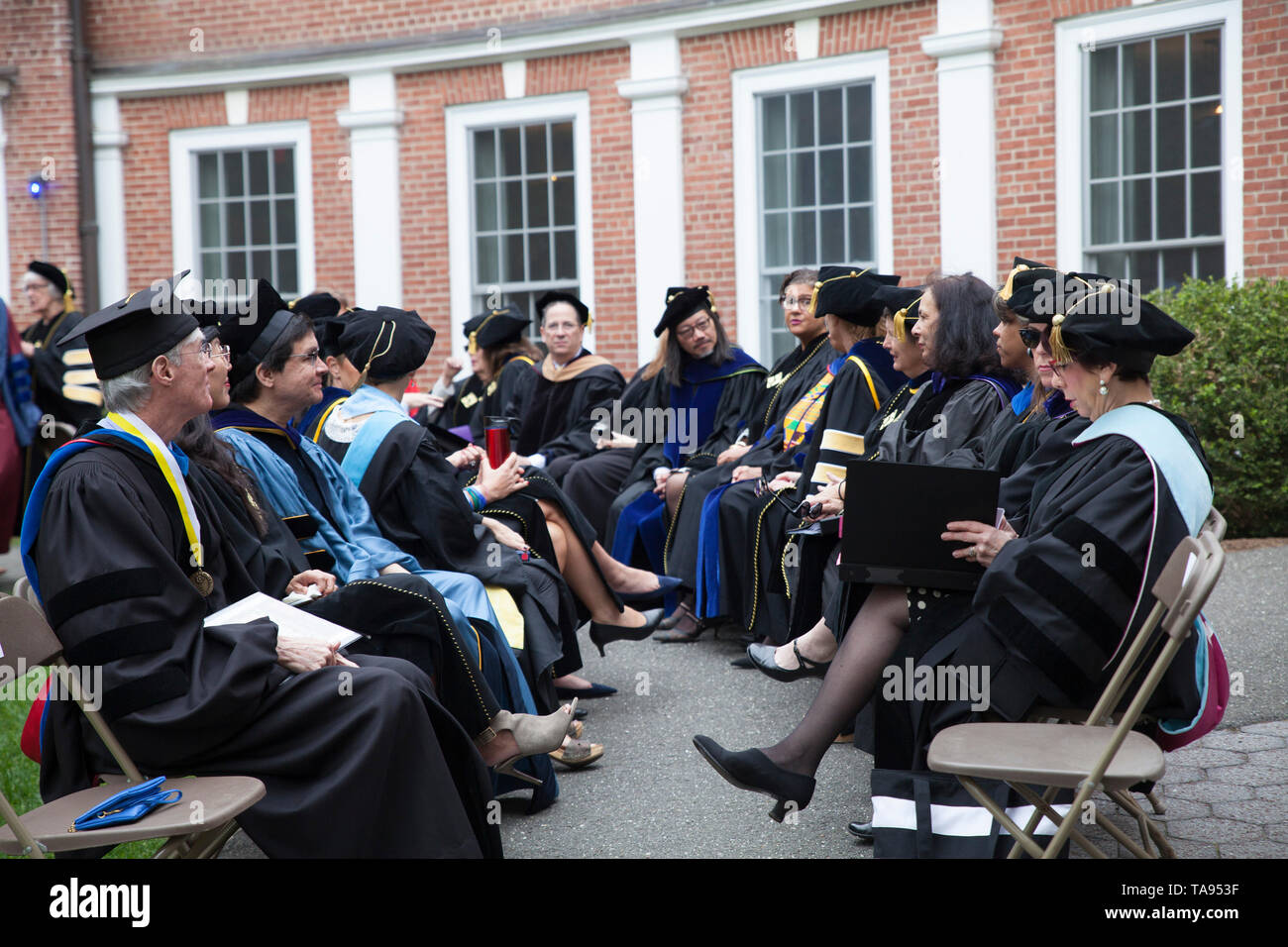 Faculty sits waiting for graduation ceremony to begin at Smith College in Northampton, Massachusetts. Stock Photo