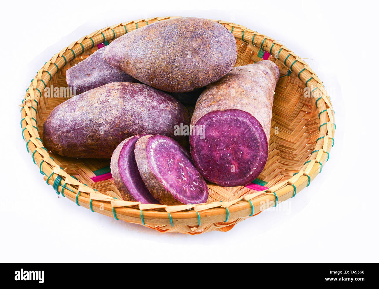 Yam purple isolated / Raw purple sweet yams sweet potato cut slice on basket isolated on white
