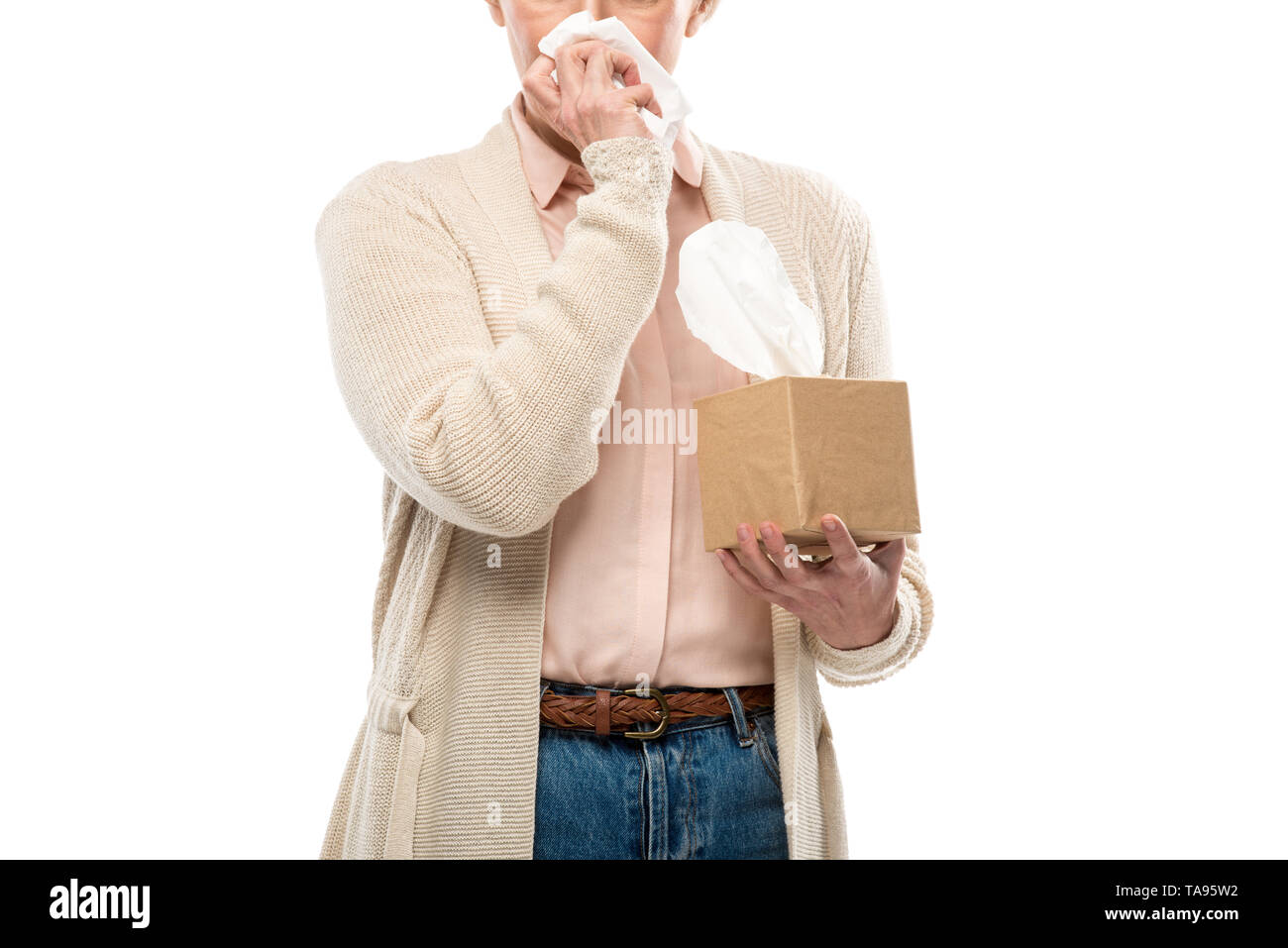 cropped view of middle aged woman crying and wiping face with tissue