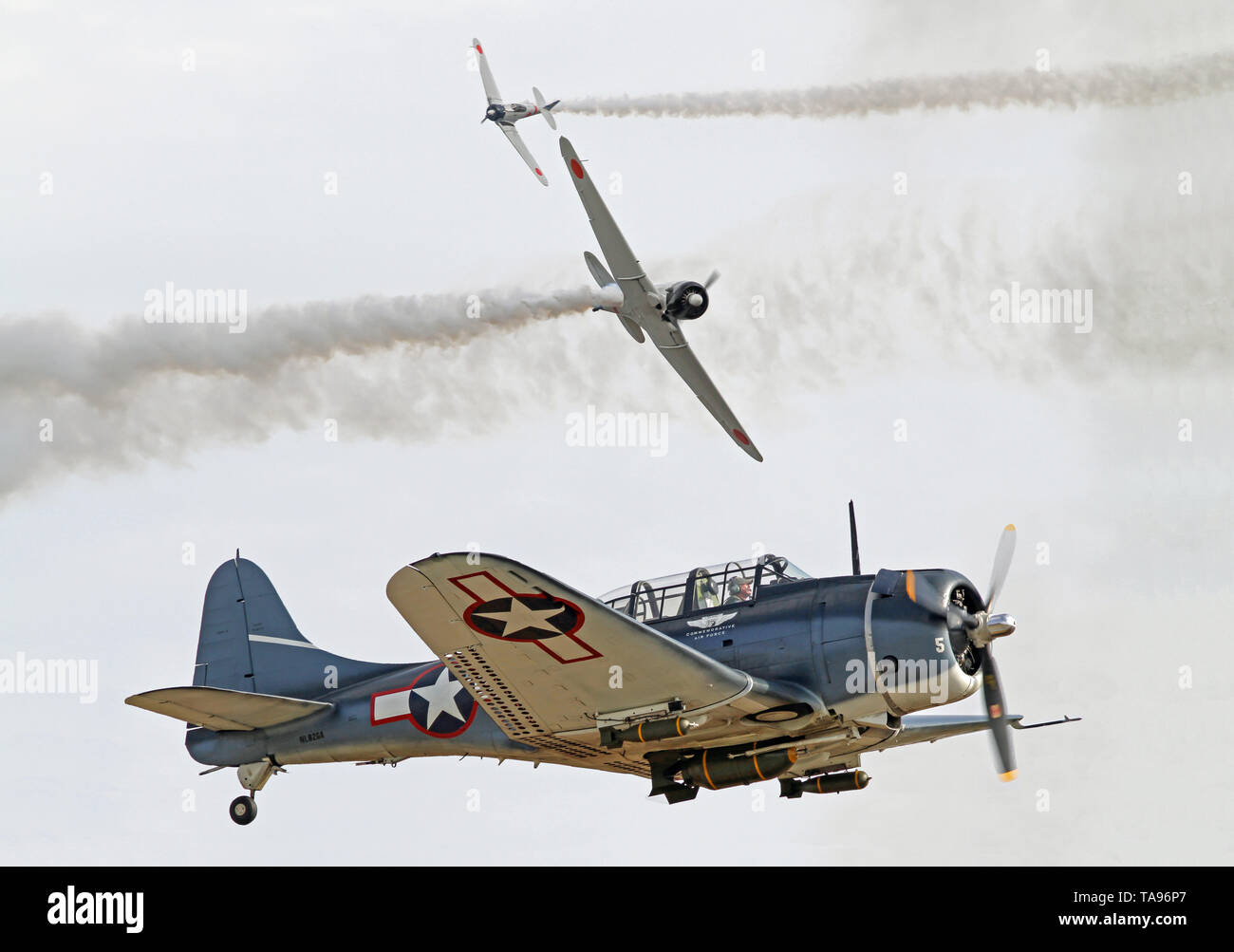 Two Japanese Zero fighters pursue a U.S. Douglas SBD Dauntless dive bomber in a recreation of the Battle of Midway during World War II. Stock Photo