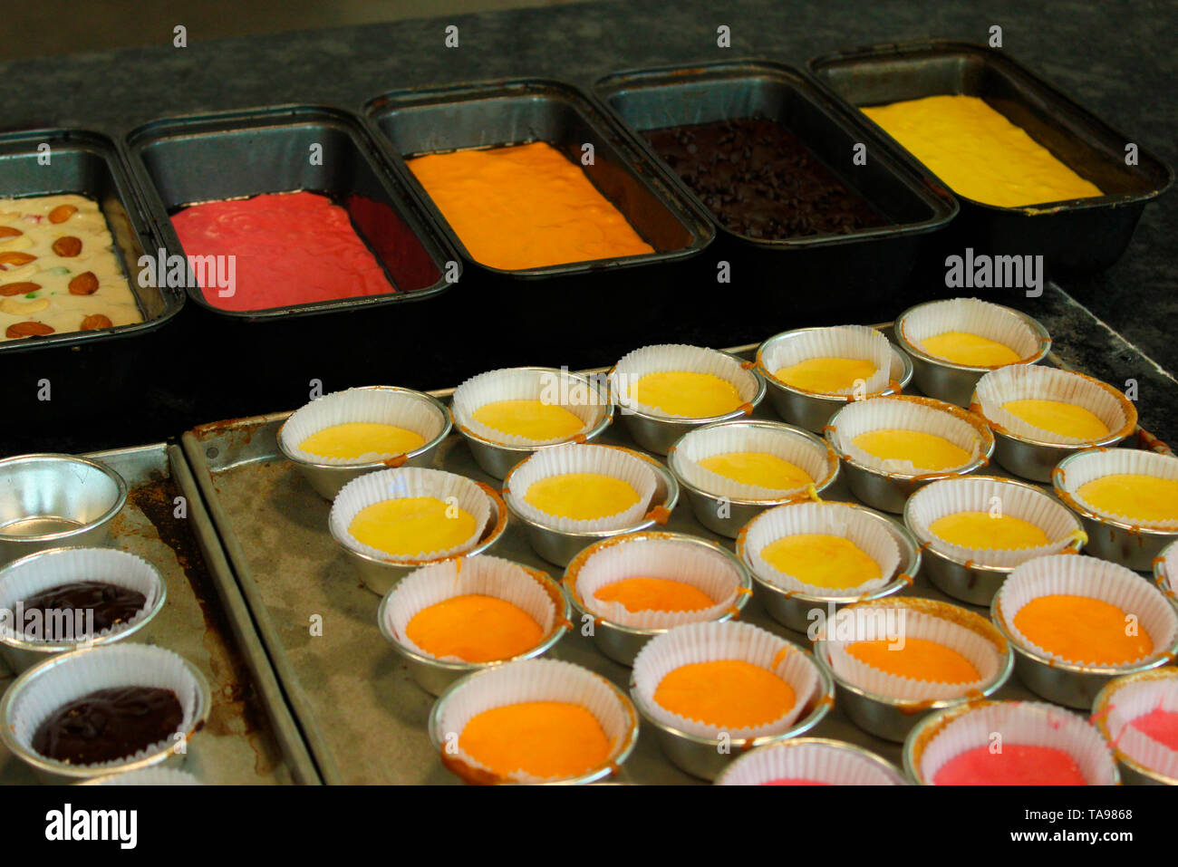 Cup cakes in different colours. Stock Photo