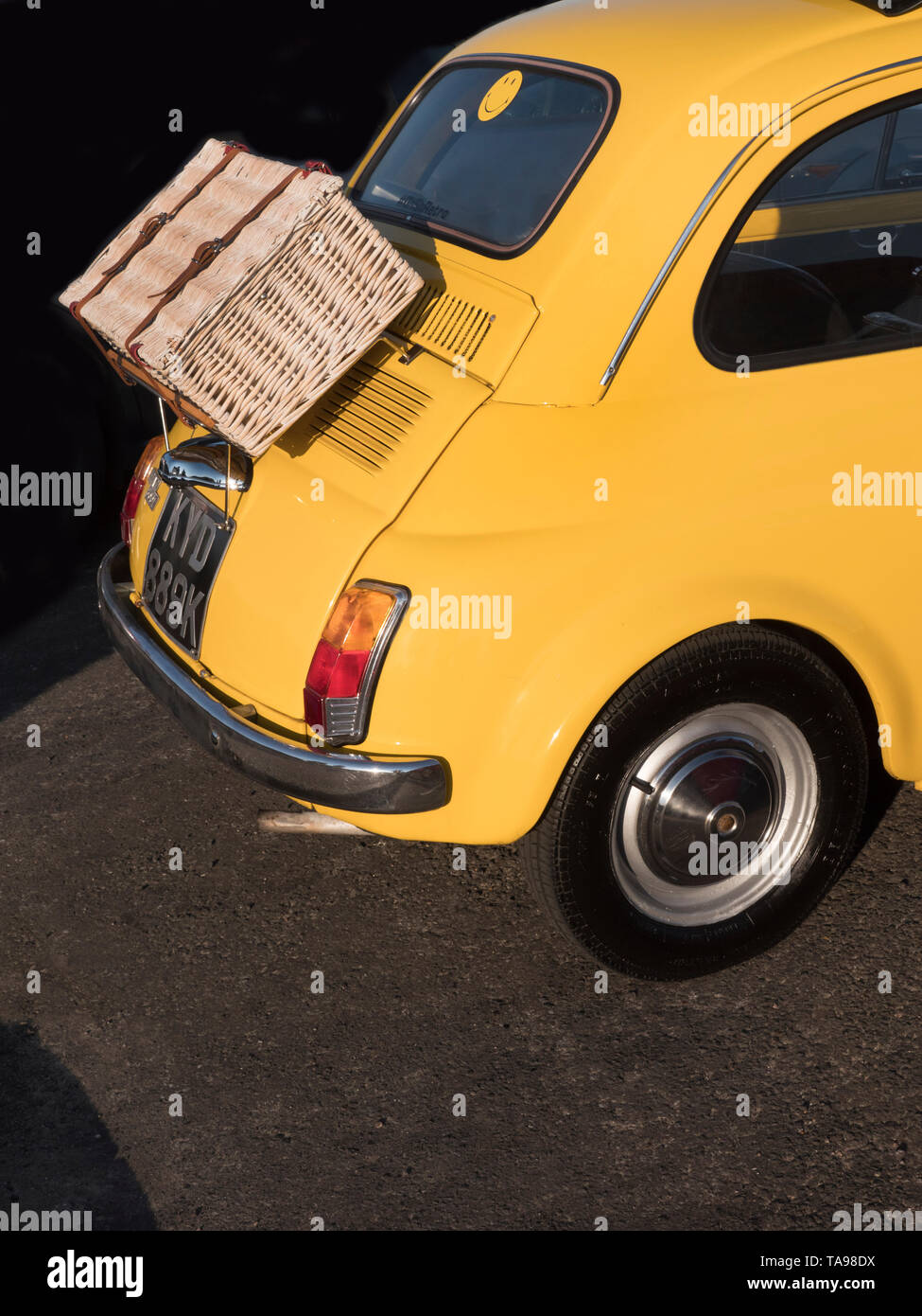 A Fiat 500 car with a picnic hamper on the boot rack Stock Photo
