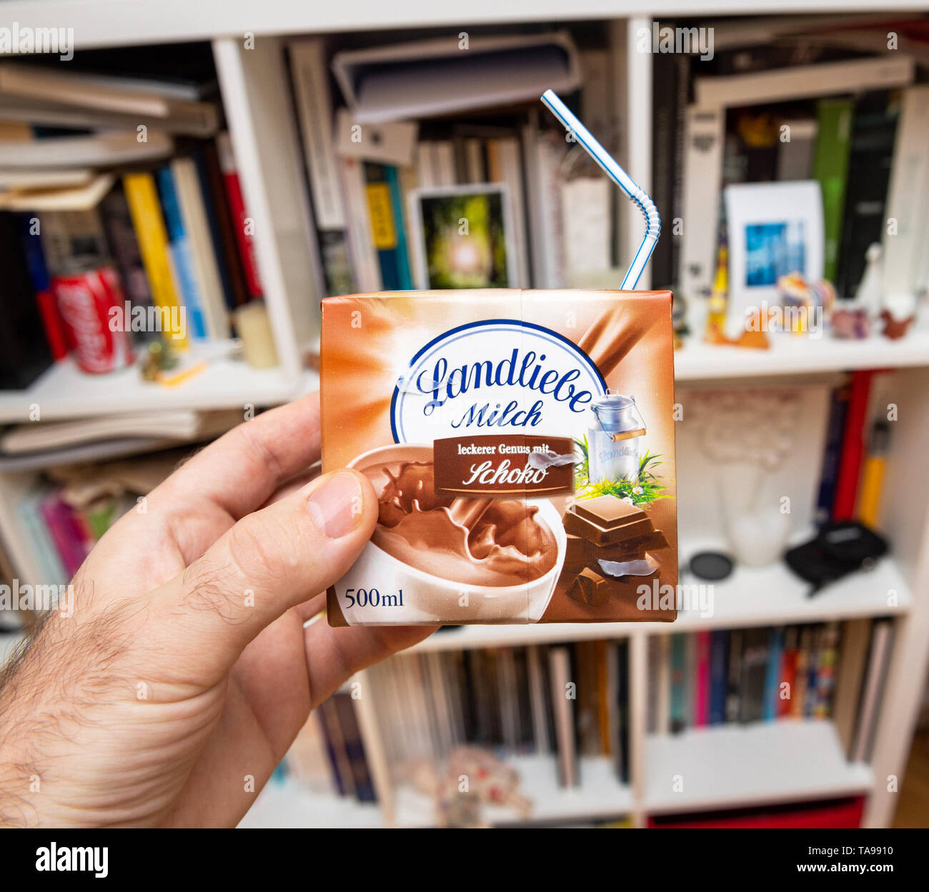 Paris, France - Mar 16, 2019: Man hand holding Landliebe chocolate milk  with plastic straw made in Germany against living room background Stock  Photo - Alamy