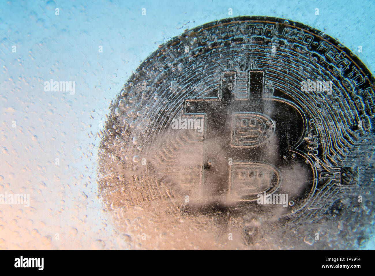 Silver Bitcoin, bit coin online digital currency frozen in the blue ice.  Concept of block chain, crypto market crash. Frozen crypto money,  depreciatio Stock Photo - Alamy