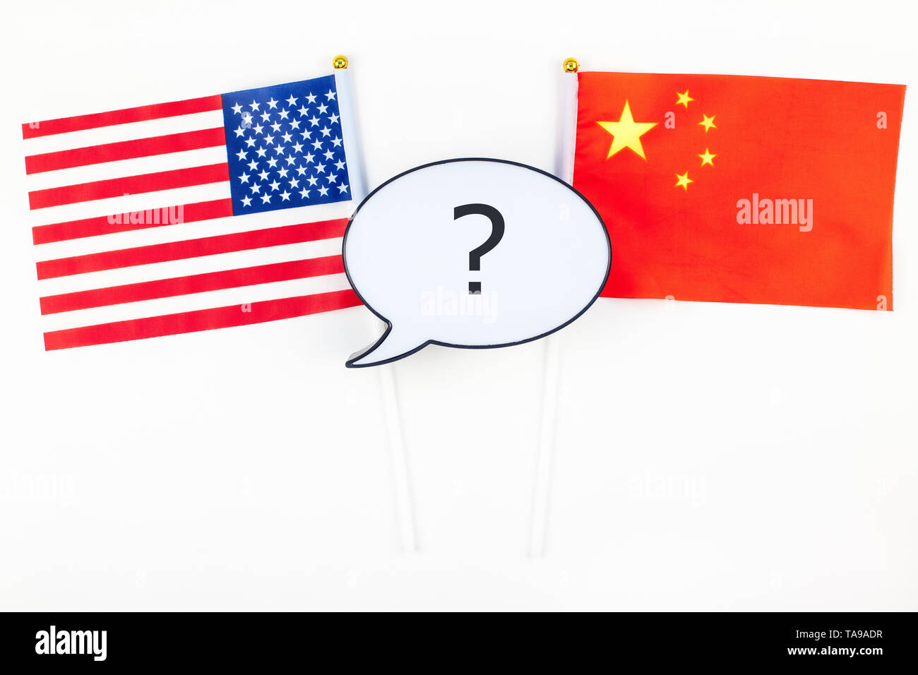 Creative top view flat lay of China and USA flag bubble lightbox with question mark and copy space white background in minimal style. Concept of trade Stock Photo