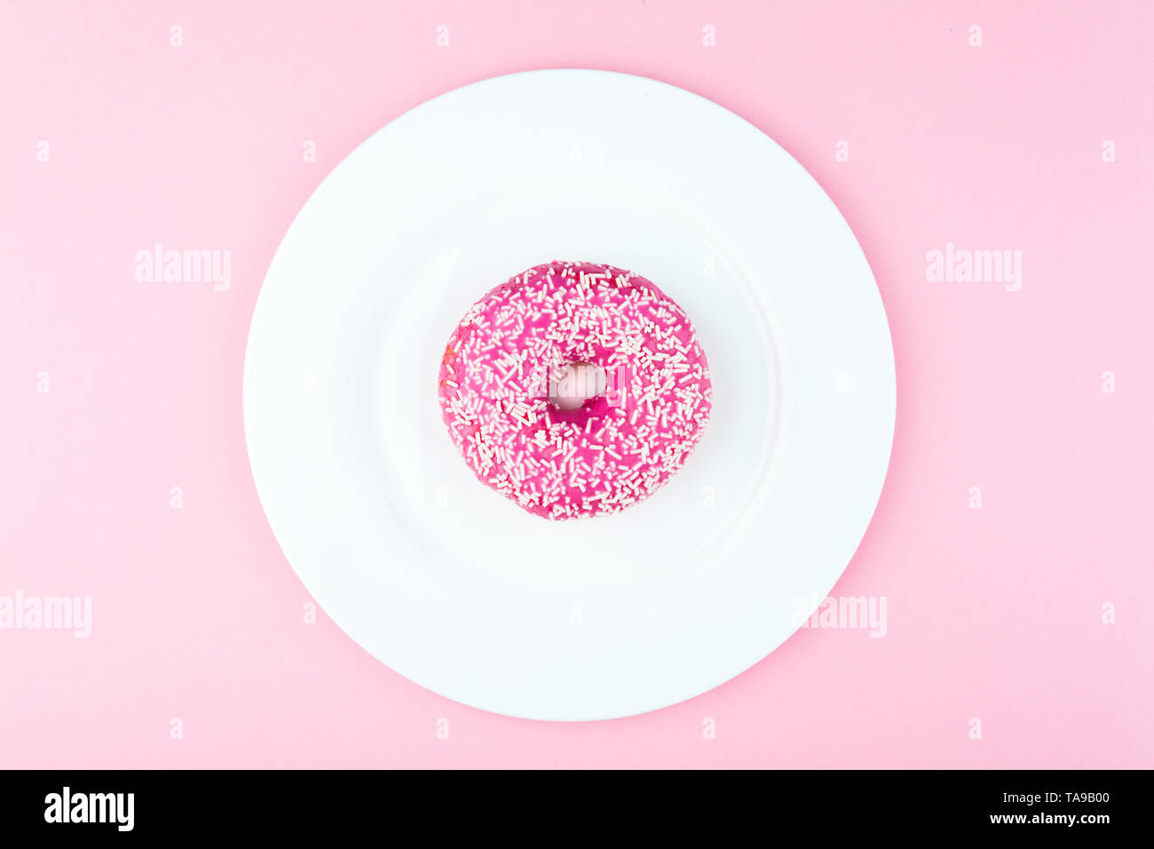 Pink round donut at bright pink background Stock Photo