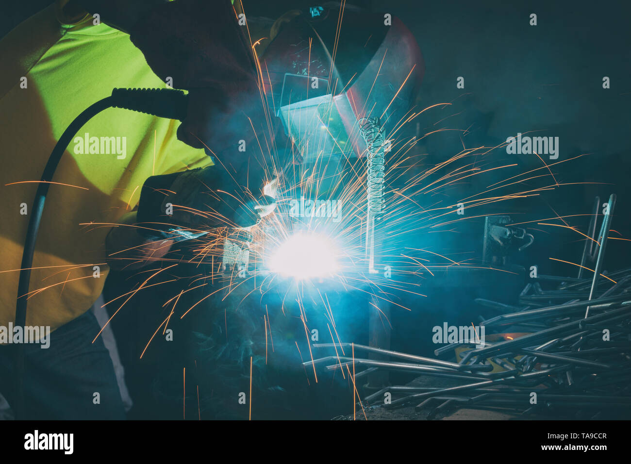 Industrial Worker at the factory or workshop welding steel elements Stock Photo