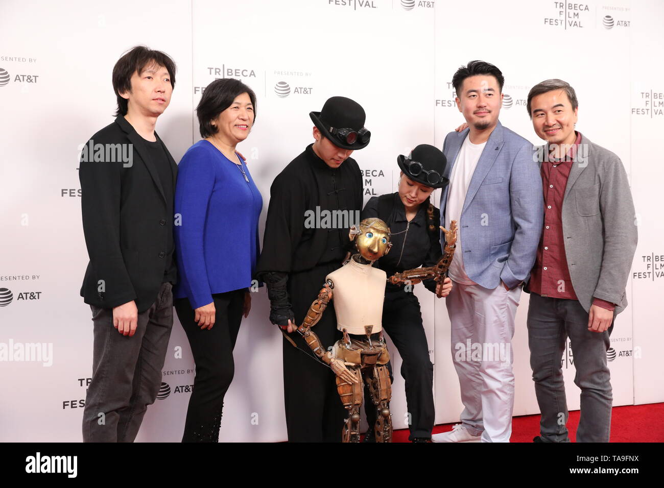 New York, USA. 28th Apr, 2019. Photo taken on April 28, 2019 shows directors S. Leo Chiang (1st R) and Sun Yang (2nd R), and other crew members posing for a group photo on the red carpet during the premiere of Chinese documentary 'Our Time Machine', in New York, the United States. 'Our Time Machine' is a touching Chinese documentary which described how Ma, a renowned Chinese photographer and artist in Shanghai, got closer to his father, managed to stick to his creative career despite various challenges, and found the true meaning of life. Credit: Luo Jingjing/Xinhua/Alamy Live News Stock Photo