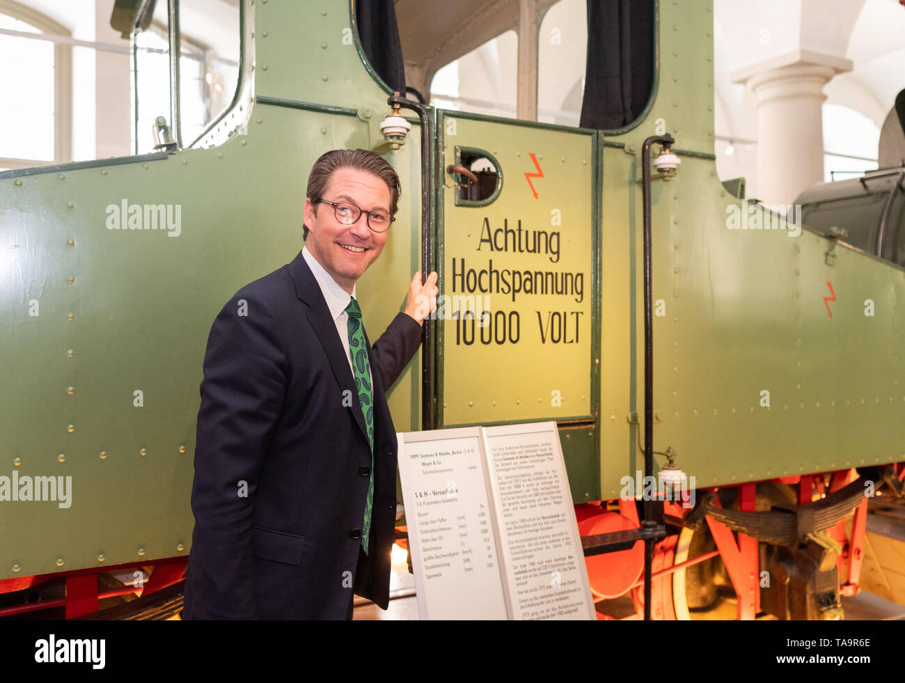 23 May 2019, Saxony, Dresden: Andreas Scheuer (CSU), Federal Minister of Transport, stands after the founding act for the German Center for Rail Transport Research in the Transport Museum at an S & H test locomotive with the inscription 'Achtung Hochspannung 10.000 Volt'. Photo: Robert Michael/dpa-Zentralbild/dpa Stock Photo