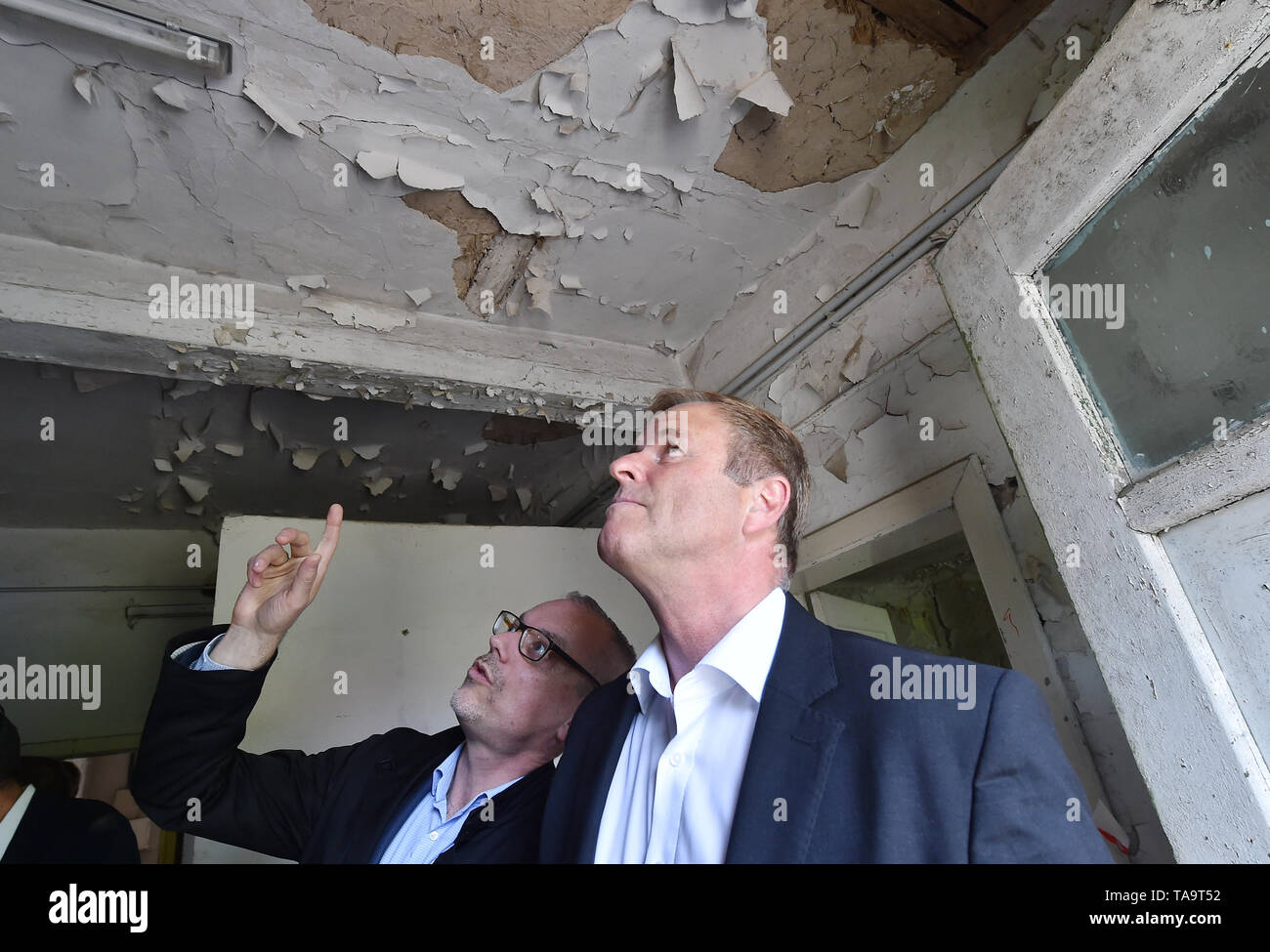 Caputh, Germany. 23rd May, 2019. Christoph Martin Vogtherr (l), General Director SPSG, shows Christian Görke (Die Linke, M), Minister of Finance of Brandenburg, damages in the old lodging house at Caputh Castle. The Stiftung Preußische Schlösser und Gärten Berlin-Brandenburg (SPSG) is currently preparing the plans for the restoration of the Logierhaus, which had been vacant since 1987. Credit: Bernd Settnik/dpa-Zentralbild/ZB/dpa/Alamy Live News Stock Photo