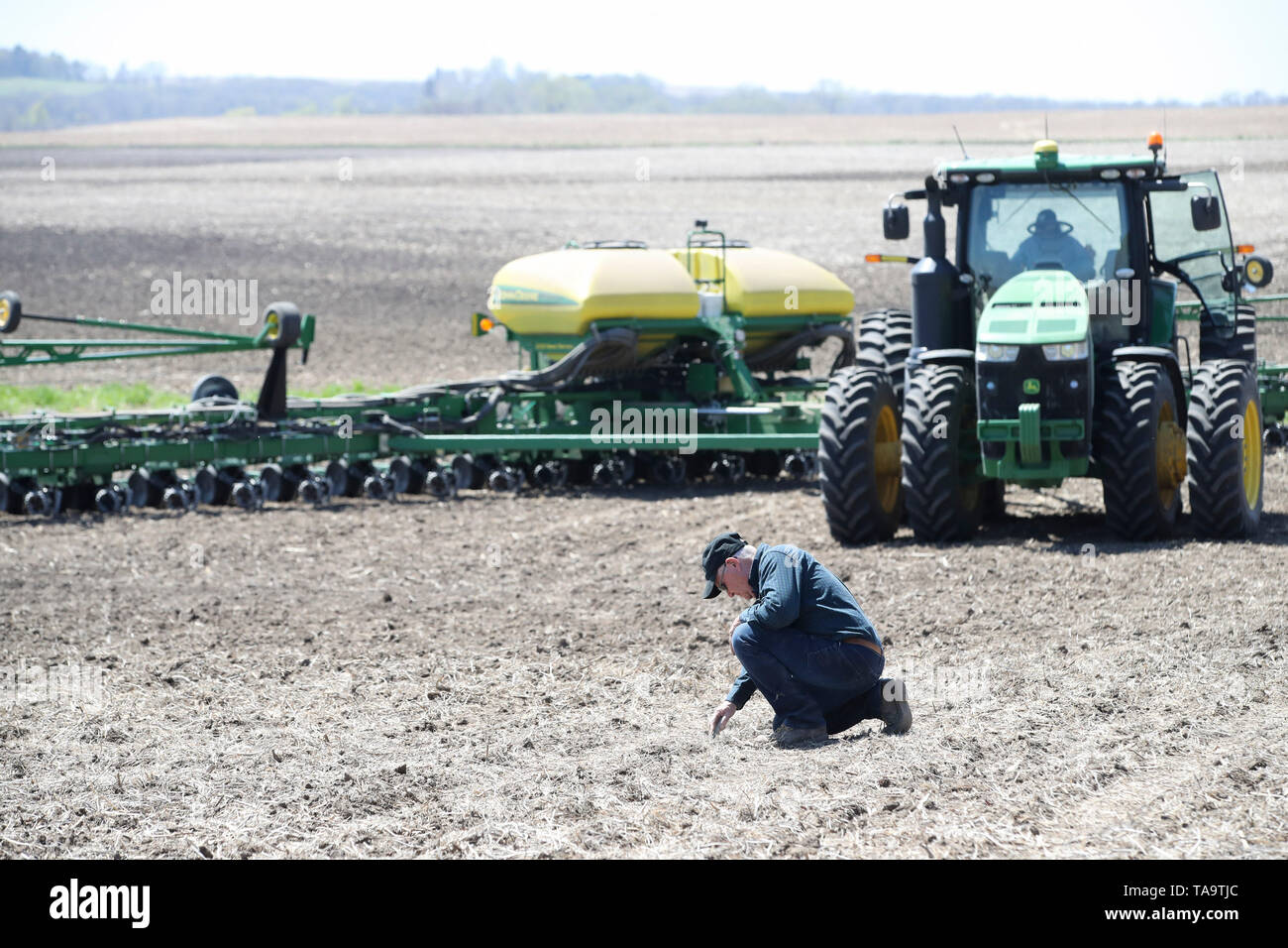 (190523) -- IOWA, May 23, 2019 (Xinhua) -- Bill Pellett examines the depth of the seeds after his son Bret plants corn with a planter machine at their family farm in Atlantic of Cass county, Iowa, the United States, April 24, 2019. Bill Pellett knows how to farm, but just like most of his peers across the country, the 71-year-old farmer is feeling less assured of what he could get from a new year of farming, as there appears to be no quick resolution of the year-long trade disputes between the United States and China. TO GO WITH 'Spotlight: Leading U.S. farming state enters new crop season a Stock Photo