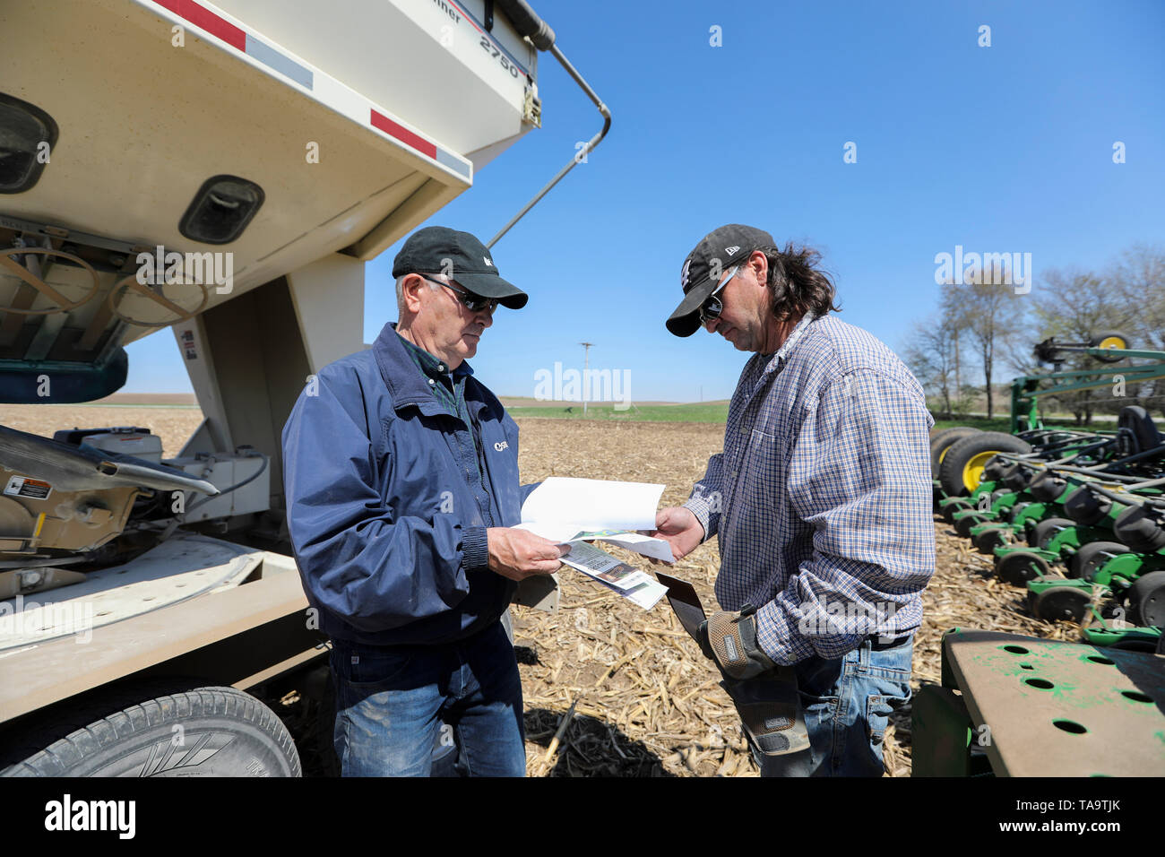 (190523) -- IOWA, May 23, 2019 (Xinhua) -- Bill Pellett and his son Bret checks the purchase record of corn seeds before planting at their family farm in Atlantic of Cass county, Iowa, the United States, April 24, 2019. Bill Pellett knows how to farm, but just like most of his peers across the country, the 71-year-old farmer is feeling less assured of what he could get from a new year of farming, as there appears to be no quick resolution of the year-long trade disputes between the United States and China.   TO GO WITH 'Spotlight: Leading U.S. farming state enters new crop season amid uncertai Stock Photo