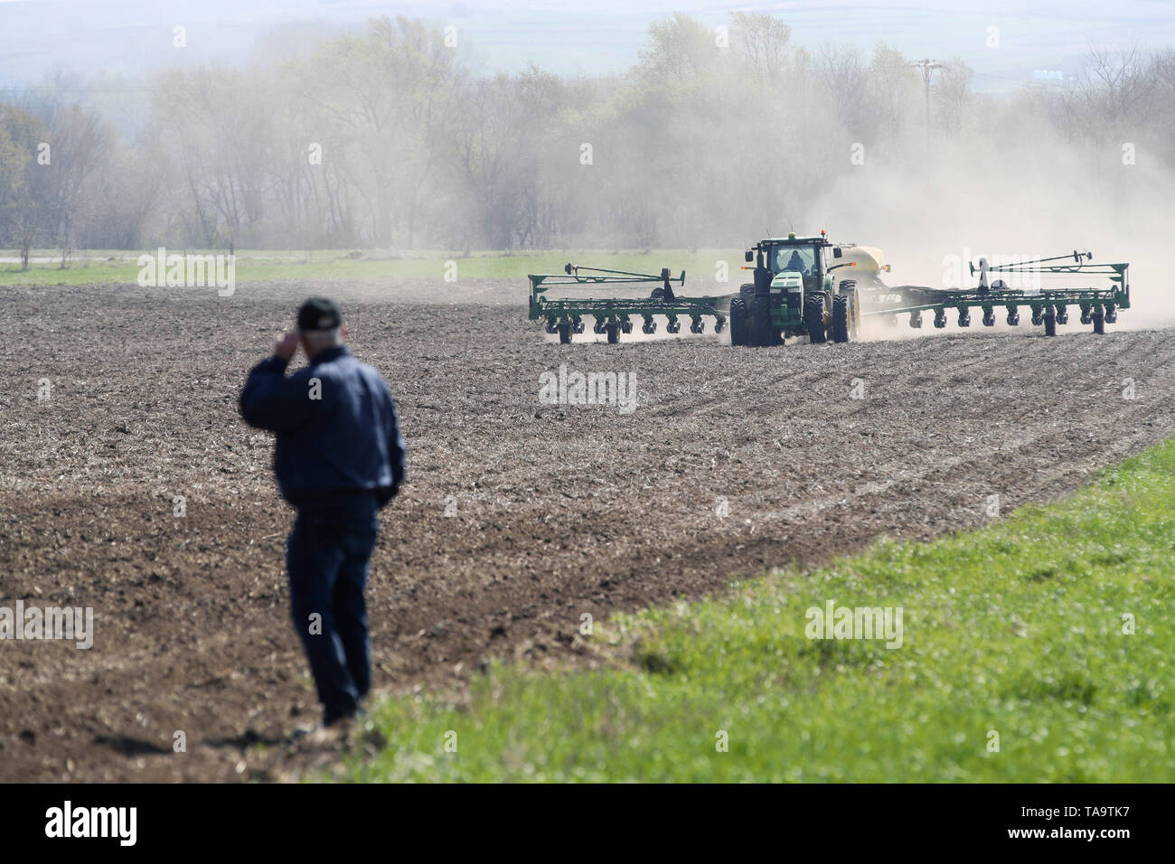 (190523) -- IOWA, May 23, 2019 (Xinhua) -- Bill Pellett watches as his son Bret plants corn with a planter machine at their family farm in Atlantic of Cass county, Iowa, the United States, April 24, 2019. Bill Pellett knows how to farm, but just like most of his peers across the country, the 71-year-old farmer is feeling less assured of what he could get from a new year of farming, as there appears to be no quick resolution of the year-long trade disputes between the United States and China.   TO GO WITH 'Spotlight: Leading U.S. farming state enters new crop season amid uncertainty over trade  Stock Photo