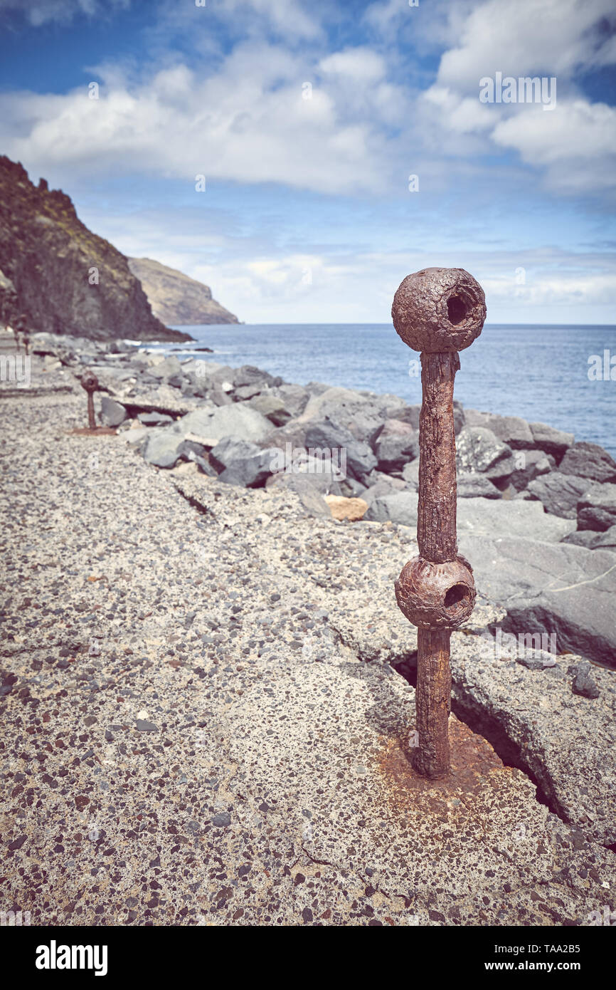 Old rusted piece of guard rail on a quay at Beach De Las Teresitas in San Andres, selective focus, color toning applied, Tenerife, Spain. Stock Photo